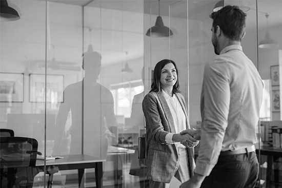 business woman and business man shaking hands