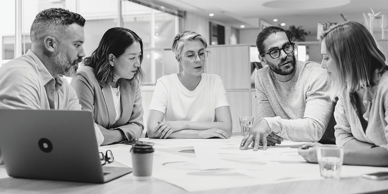 group of business people having a meeting with paperwork and laptop