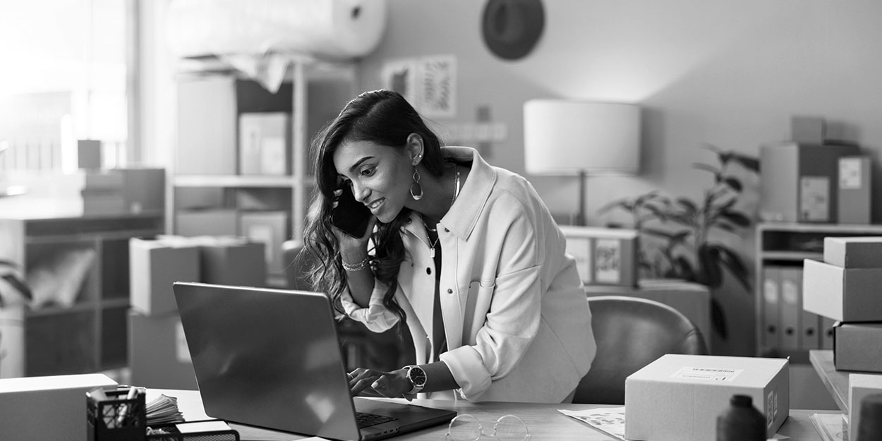 a female business owner making a phone call in her retail store