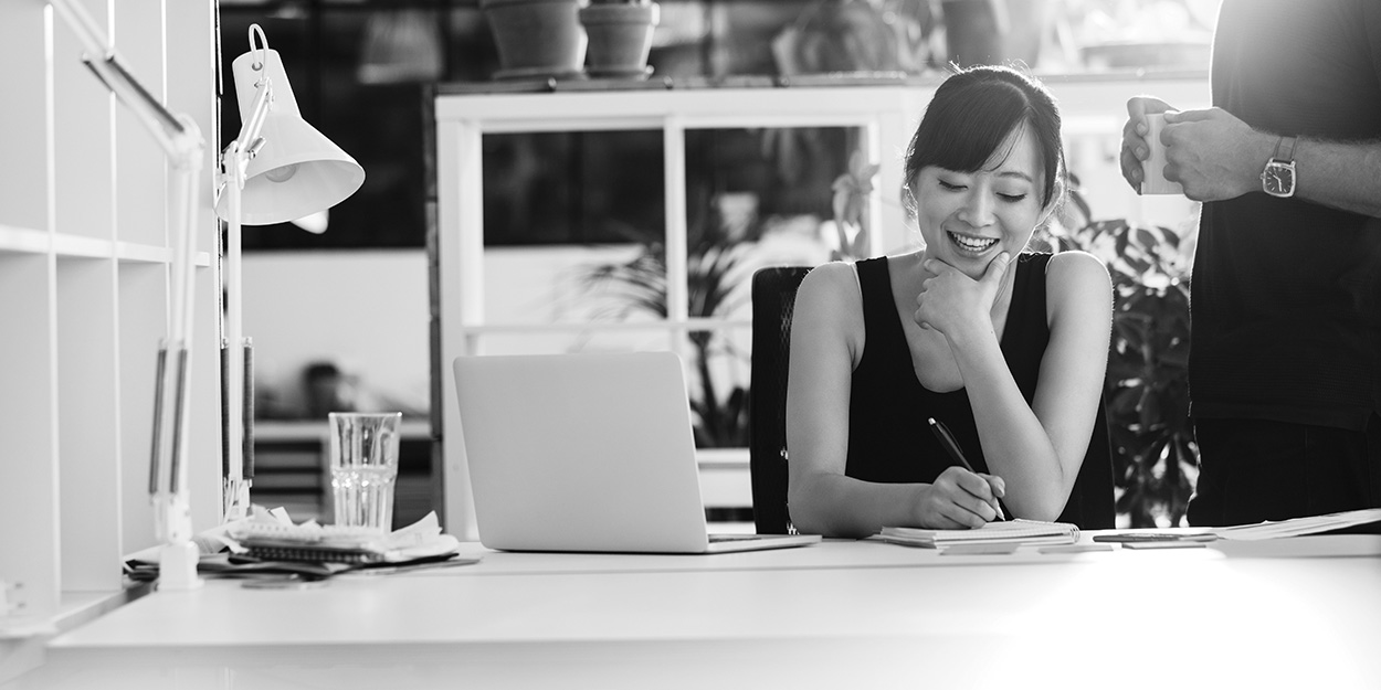 small business owner happy at her desk