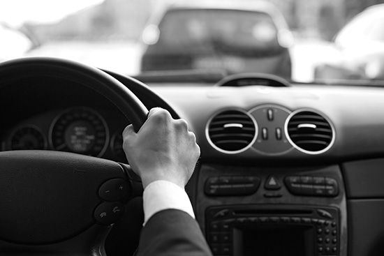 hands on a steering wheel inside a car
