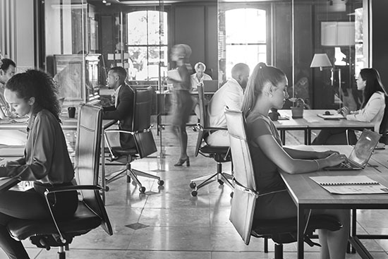 Corporate office with workers at multiple desks