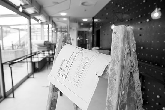 a construction plan sitting over a ladder on a construction site